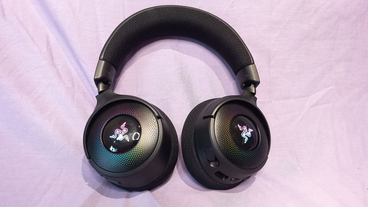 Razer Kraken V4 gaming headset on a cloth background with RGB enabled.